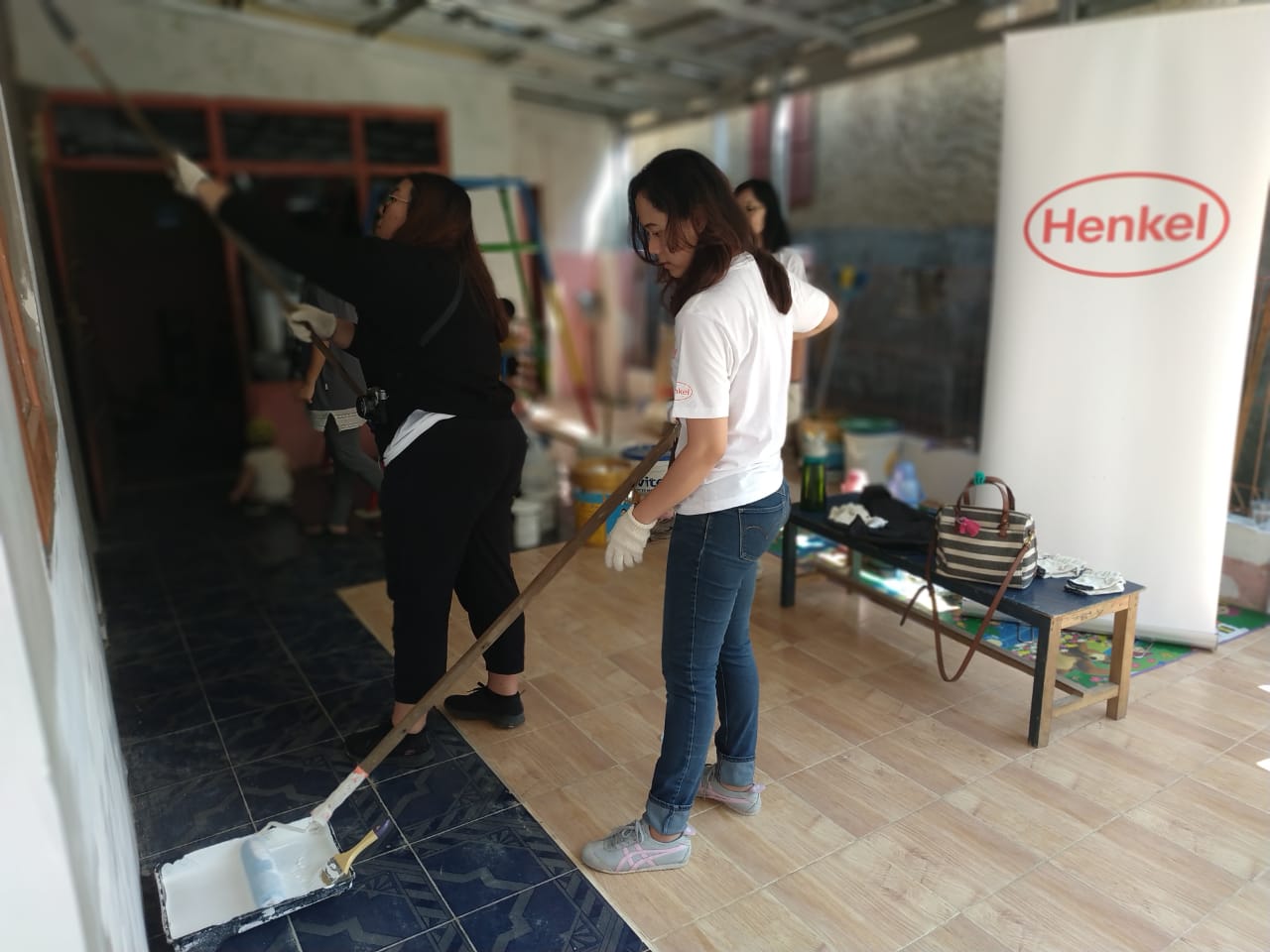 Employees painting the classroom walls.