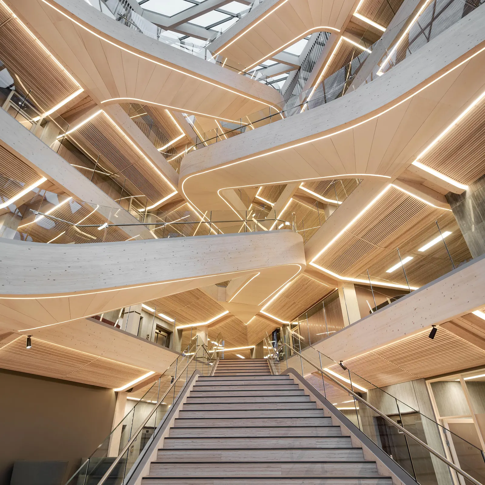 Entrance area with wooden galleries and a staircase in the middle of the picture