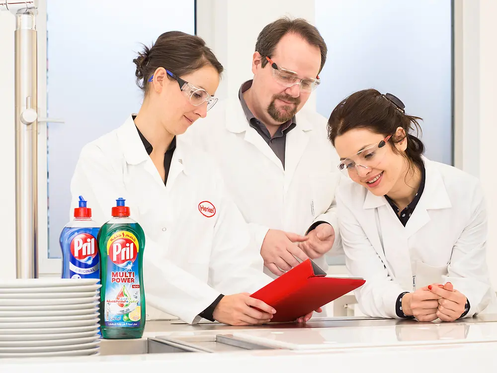 Three employees proving report in lab