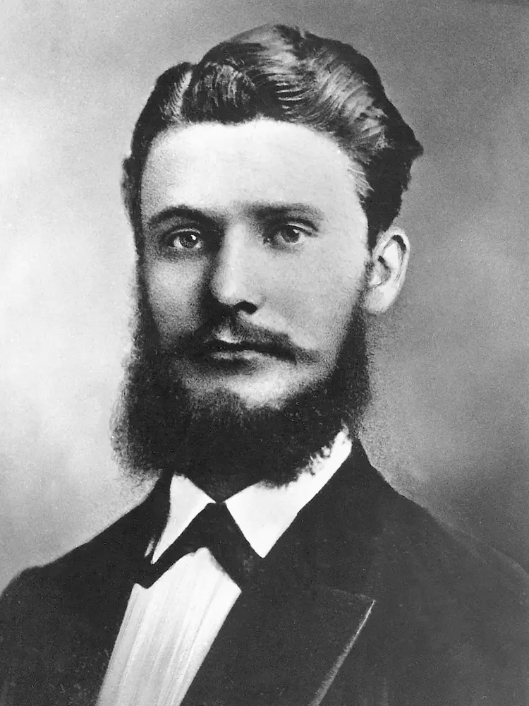 Historic black-and-white portrait of Frtiz Henkel in formal attire with a full beard and neatly combed hair.